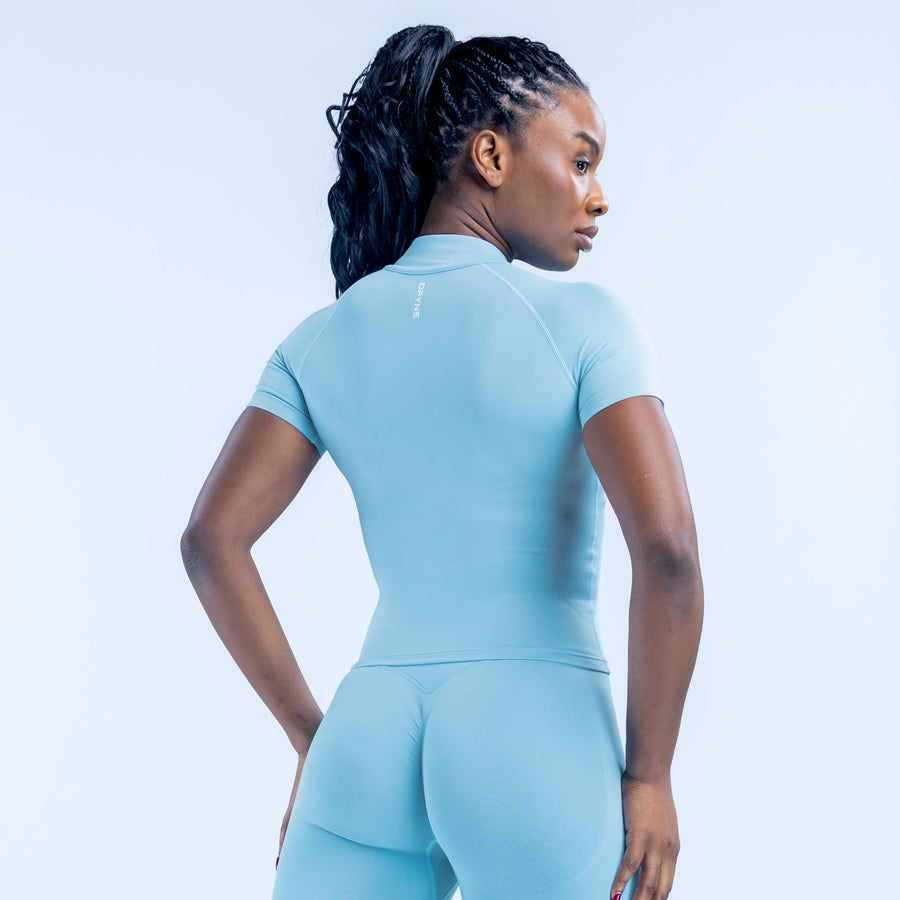 Light blue short-sleeve athletic top with zip, back view