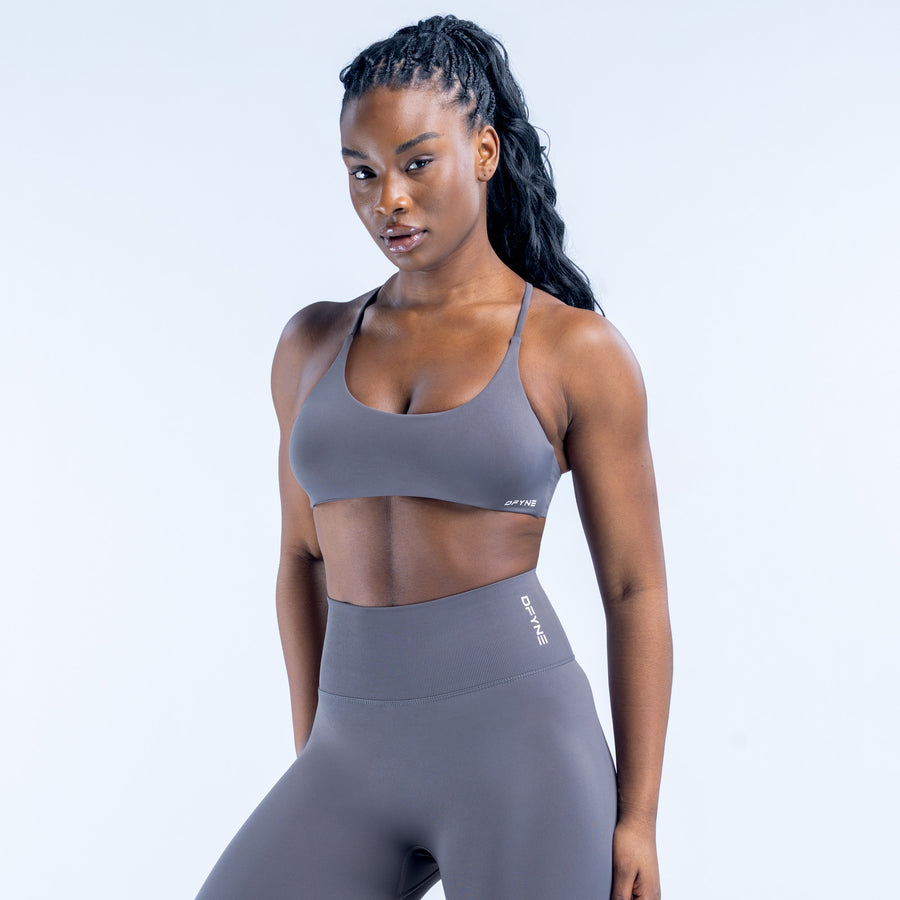 Twist-back sports bra in dark gray with wide scoop neckline and thin straps