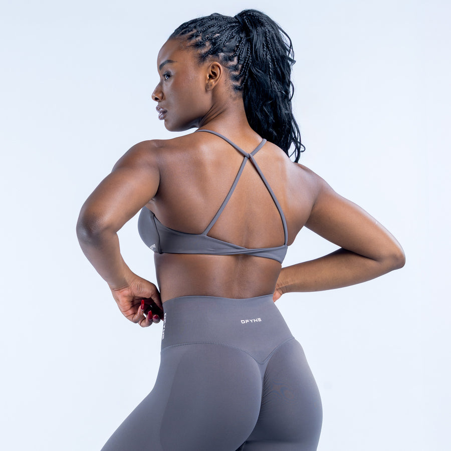 Twist-back sports bra showing open back with crossing straps over shoulders
