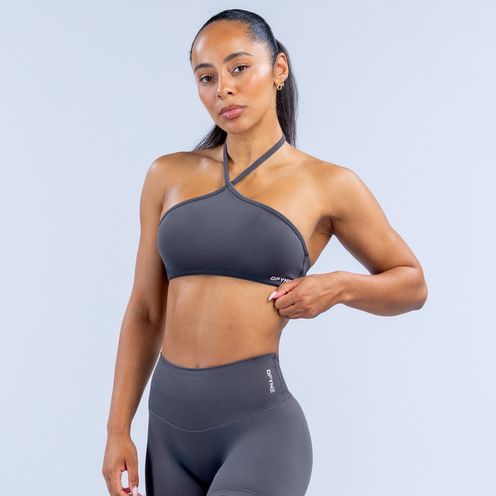 Dark gray high-neck halter sports bra, front view with narrow straps and elastic band