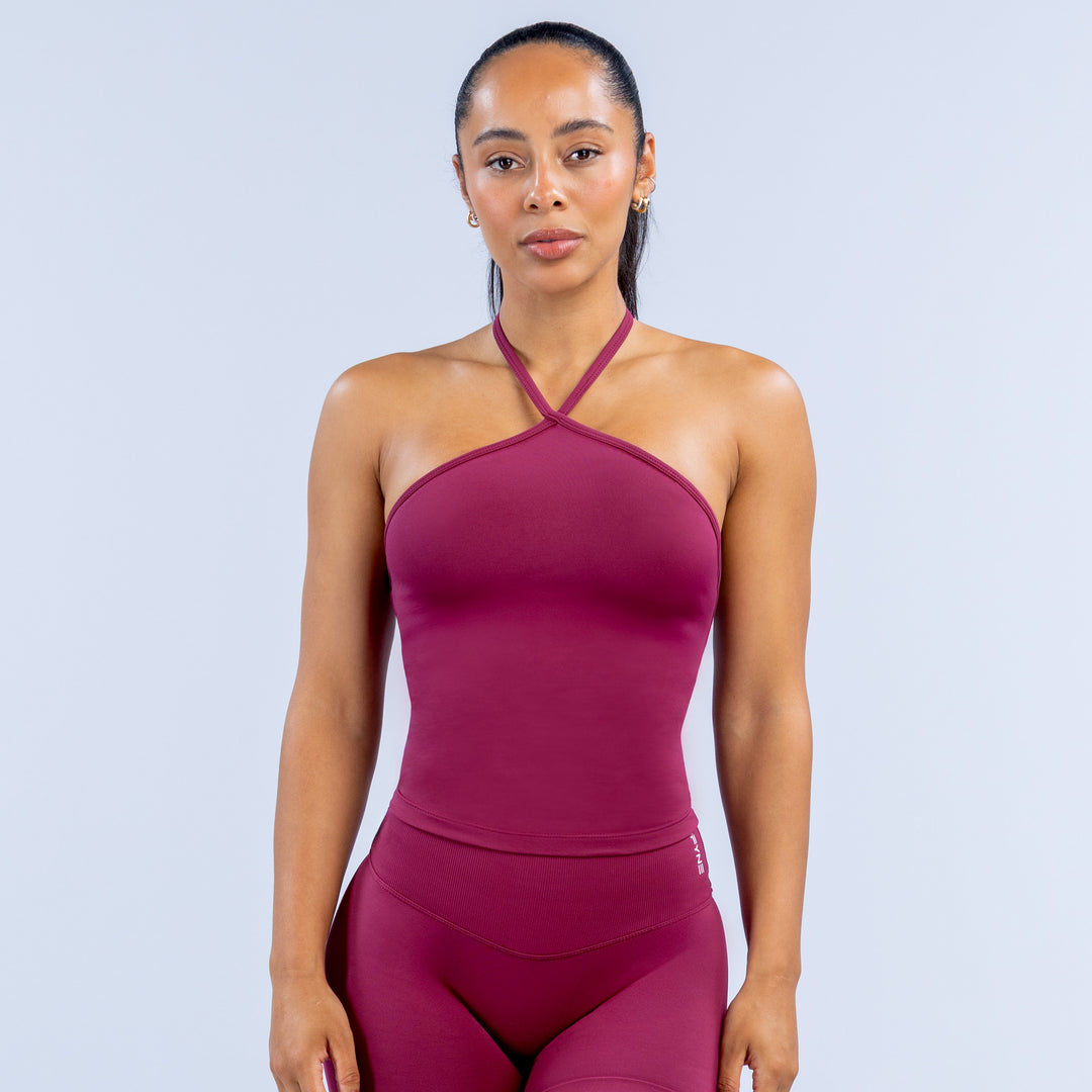 Maroon halter longline top with cross halter straps and smooth fitted bust