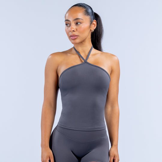 Dark gray longline halter workout top with cross halter straps, fitted bodice.
