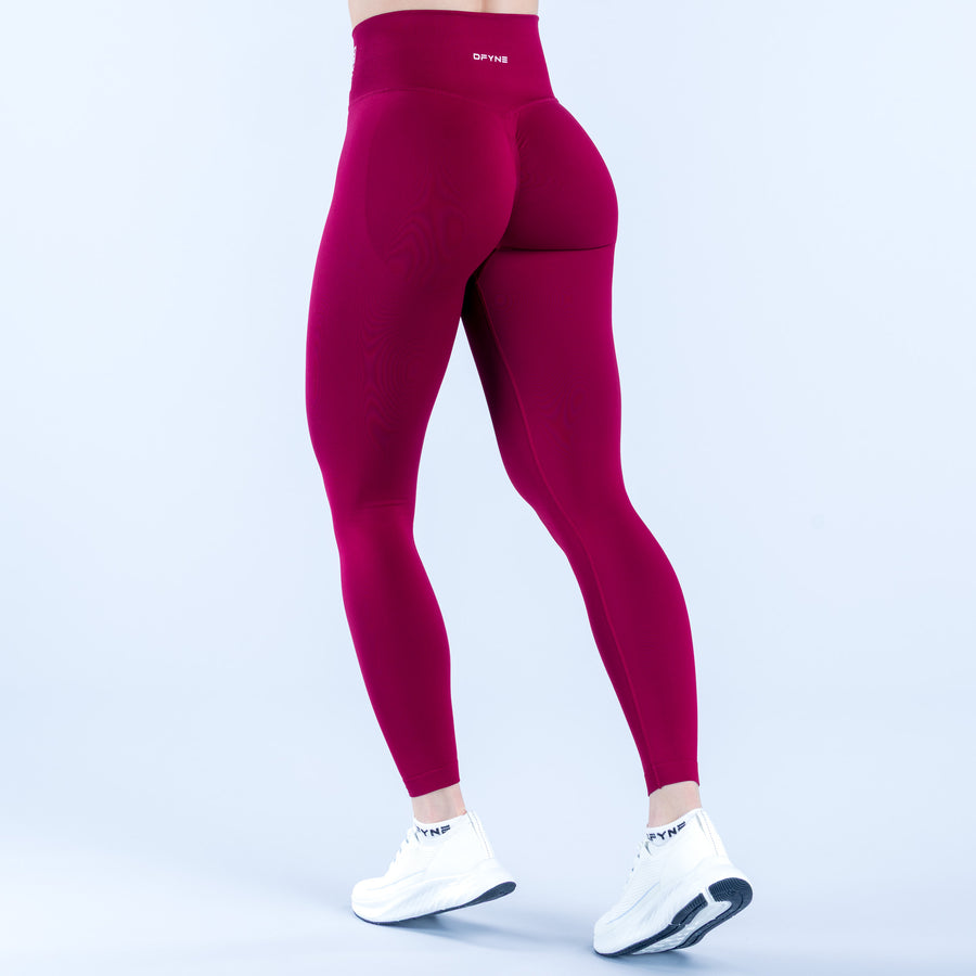 Burgundy high-rise leggings with smooth waistband and tapered full-length fit