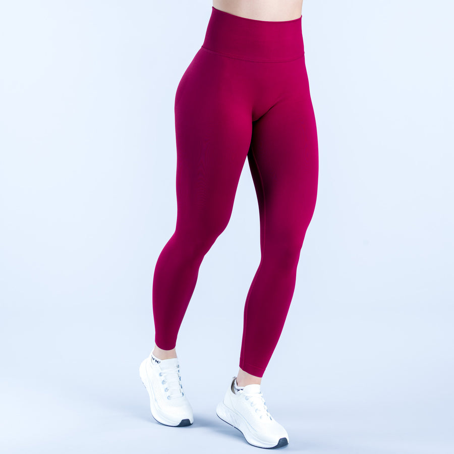 Burgundy high-rise leggings with ankle-length slim fit and subtle logo at hem