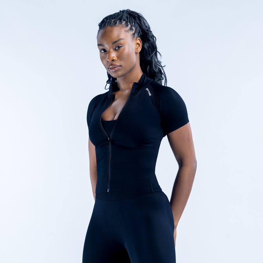 Black short-sleeve zip-front athletic set with fitted top and leggings