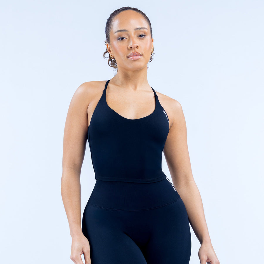 Women's black strappy sports top with scoop neckline, fitted racerback