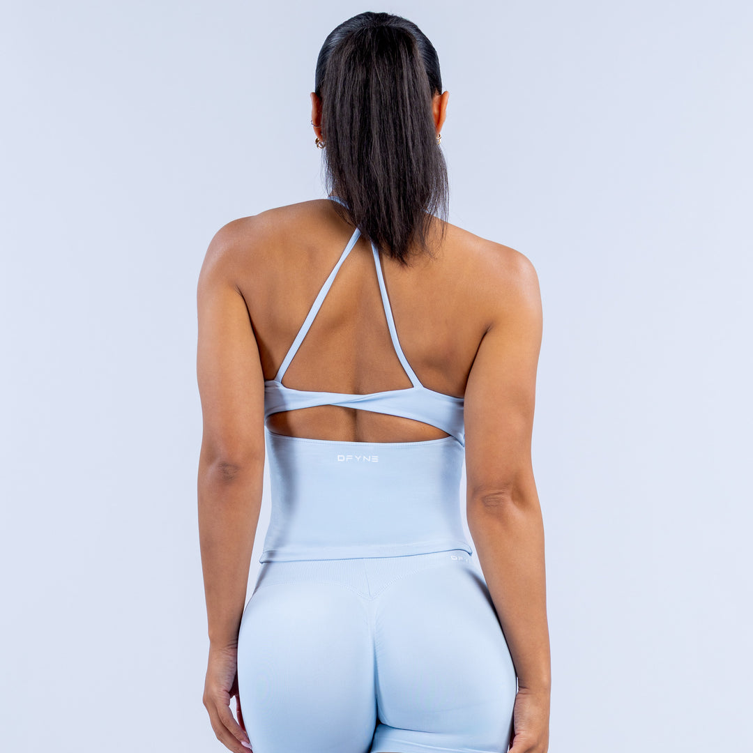 Light blue sports top back view with crisscross straps and racerback cutout