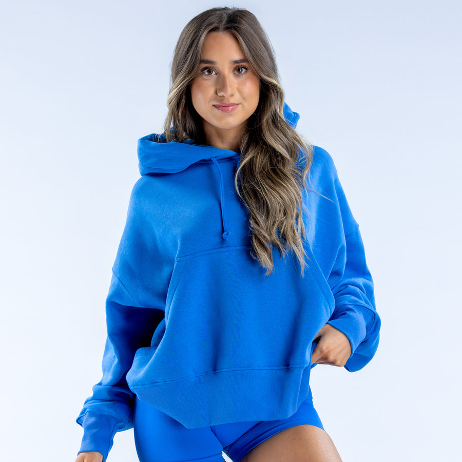 Blue pullover hoodie with hood and front pocket, long sleeves with ribbed cuffs