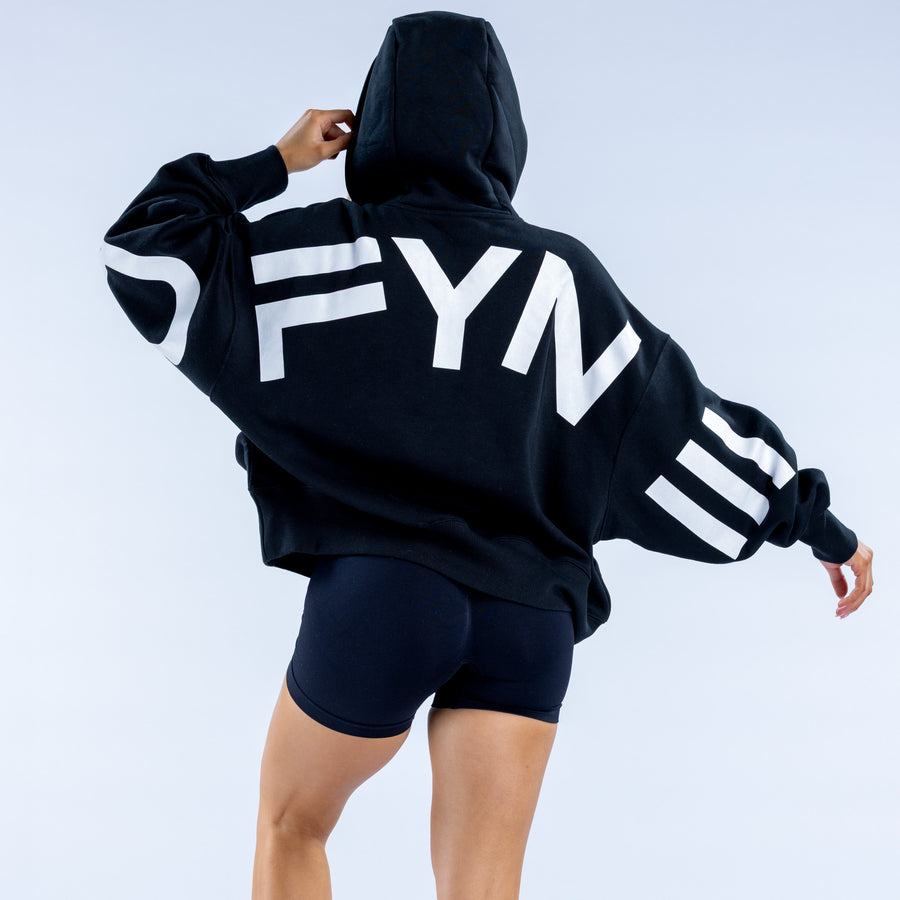 Black pullover hoodie with oversized white back text graphic and drawstring hood