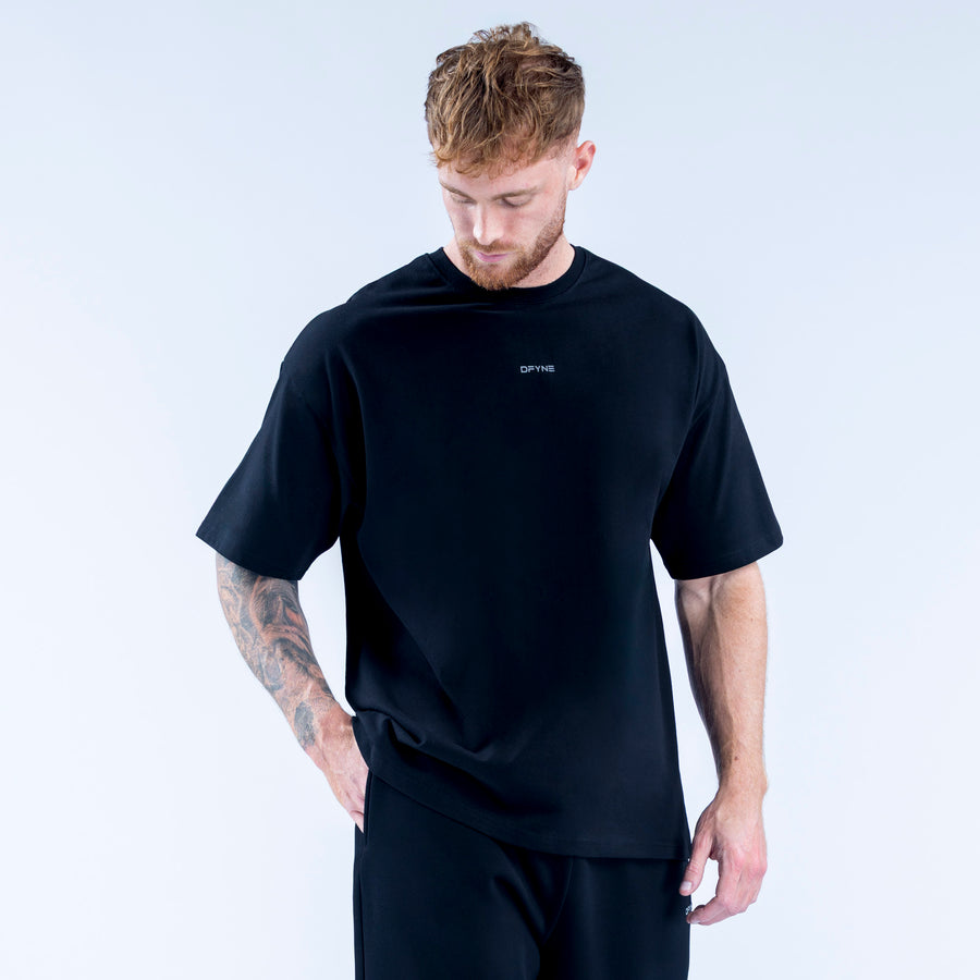 Black crew-neck T-shirt with small chest logo and short sleeves, relaxed fit.