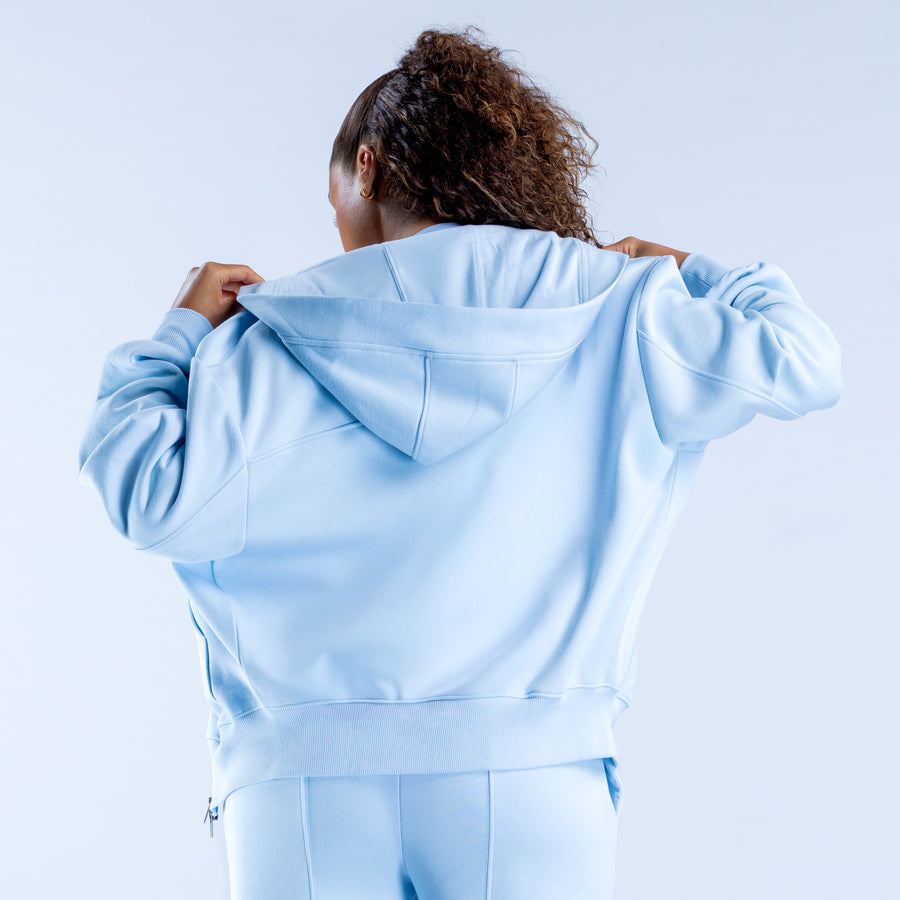 Light blue zip-up hoodie with hood, kangaroo pocket, and long sleeves