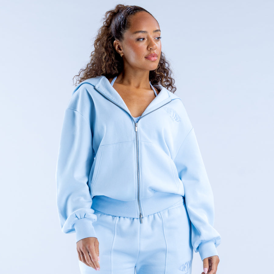 Light blue zip-up hoodie with hood, front zipper, and kangaroo pocket