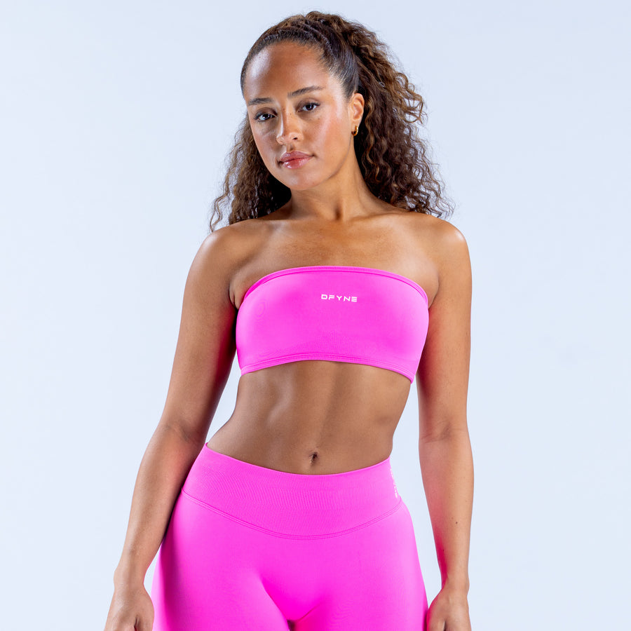 Pink bandeau sports top with wide band and snug fit, front view