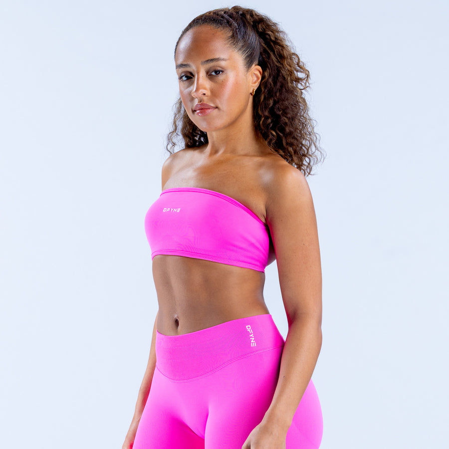 Pink bandeau sports top with wide band and smooth stretch fabric, side view