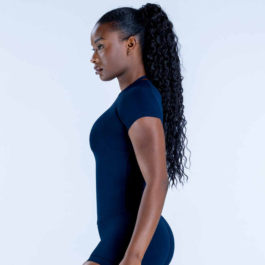 Navy fitted short-sleeve athletic top, side view