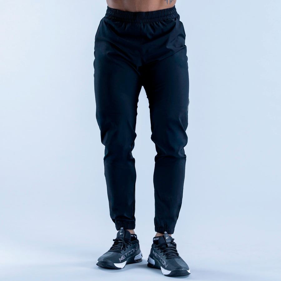 Dark navy training jogger pants with elastic waistband and tapered ankle cuffs