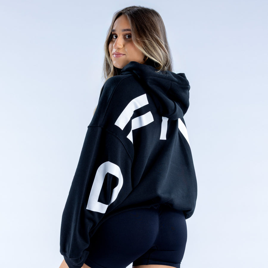Black pullover hoodie with large white sleeve graphic and drawstring hood