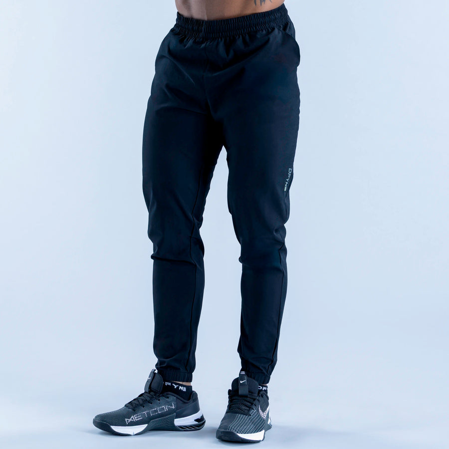 Dark navy training jogger pants with cuffed legs and elastic drawstring waistband