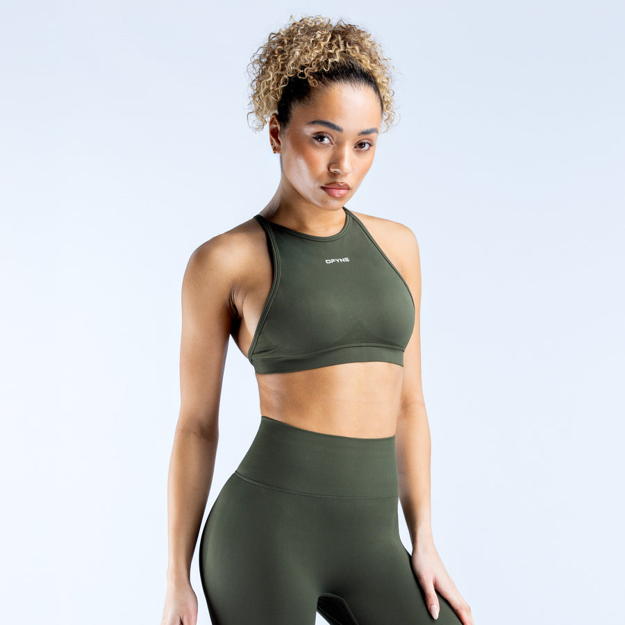 Dark green high-neck sports bra, angled front view with backless cut
