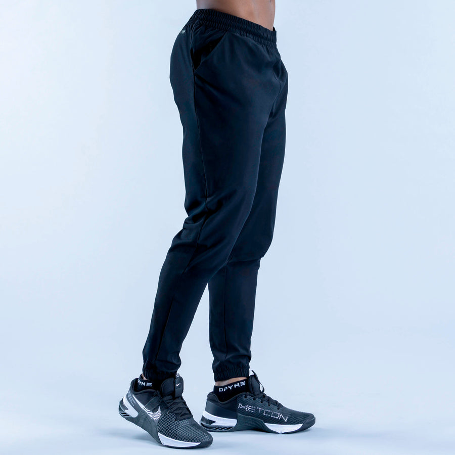 Dark navy training jogger pants, side view, elastic waist and tapered fit