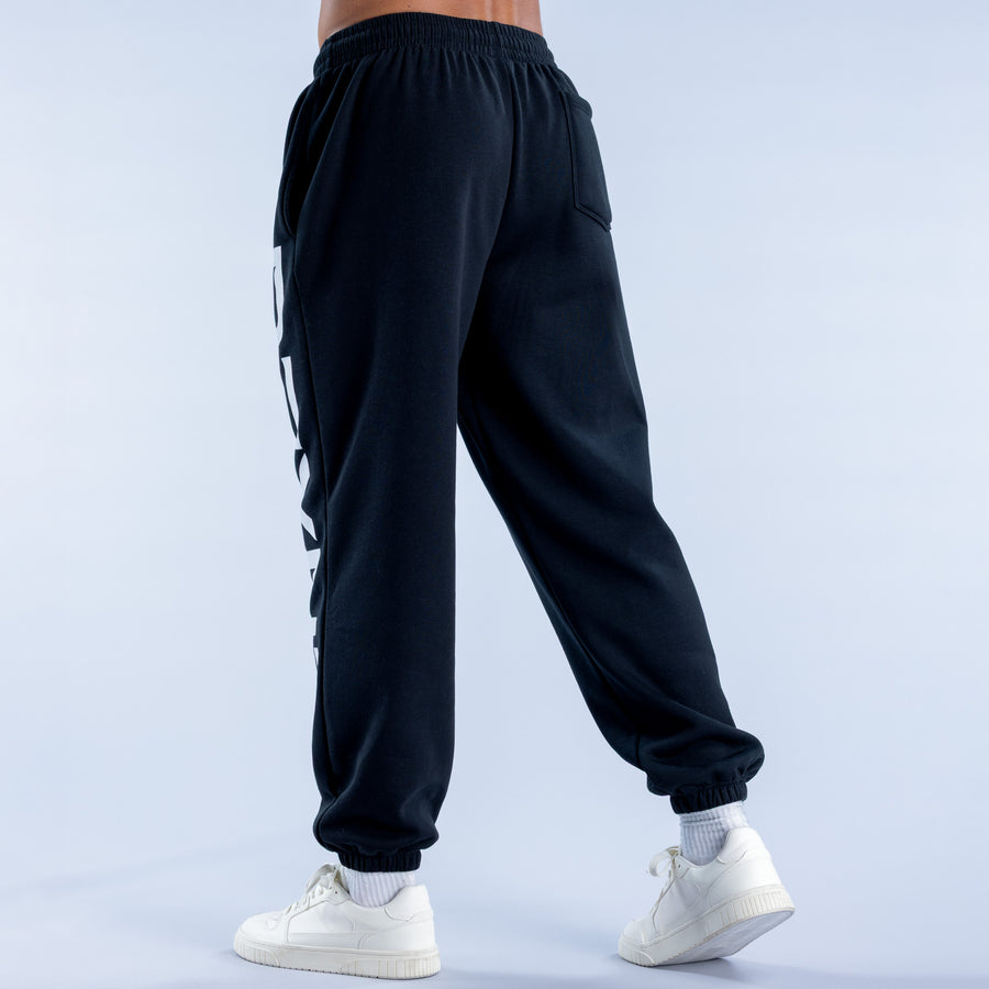 Black cuffed jogger pants, back view with elastic waistband and ankle cuffs