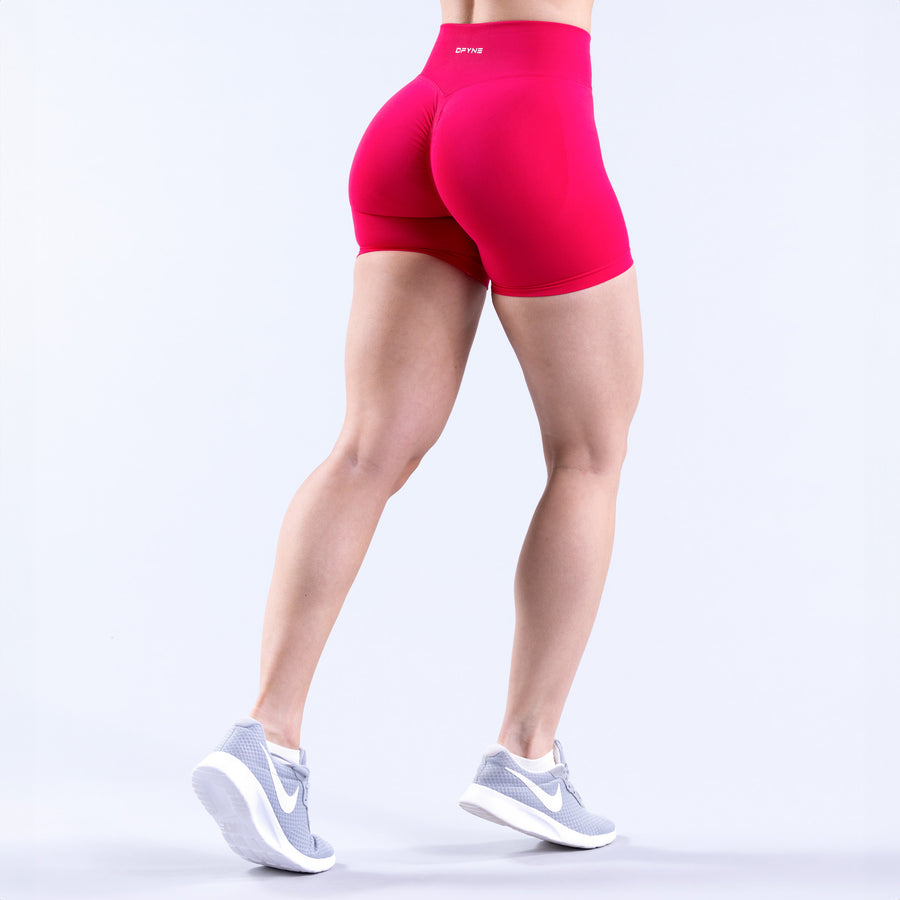 Fuchsia athletic shorts from behind, form-fitting stretch fabric
