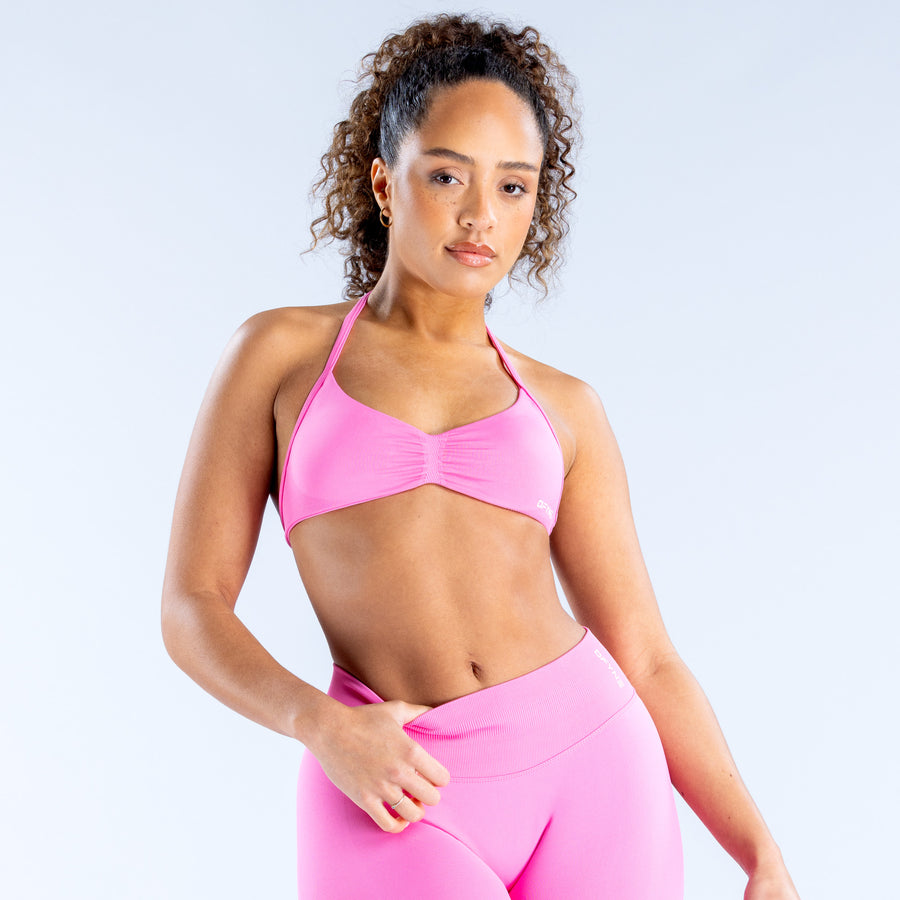 Pink strappy sports bra with thin straps and ruched bust
