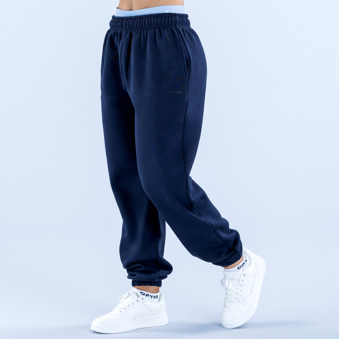 Navy joggers with elastic waistband and tapered ribbed cuffs, side pockets.