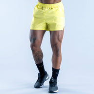 Lime yellow training shorts with elastic waistband and relaxed fit