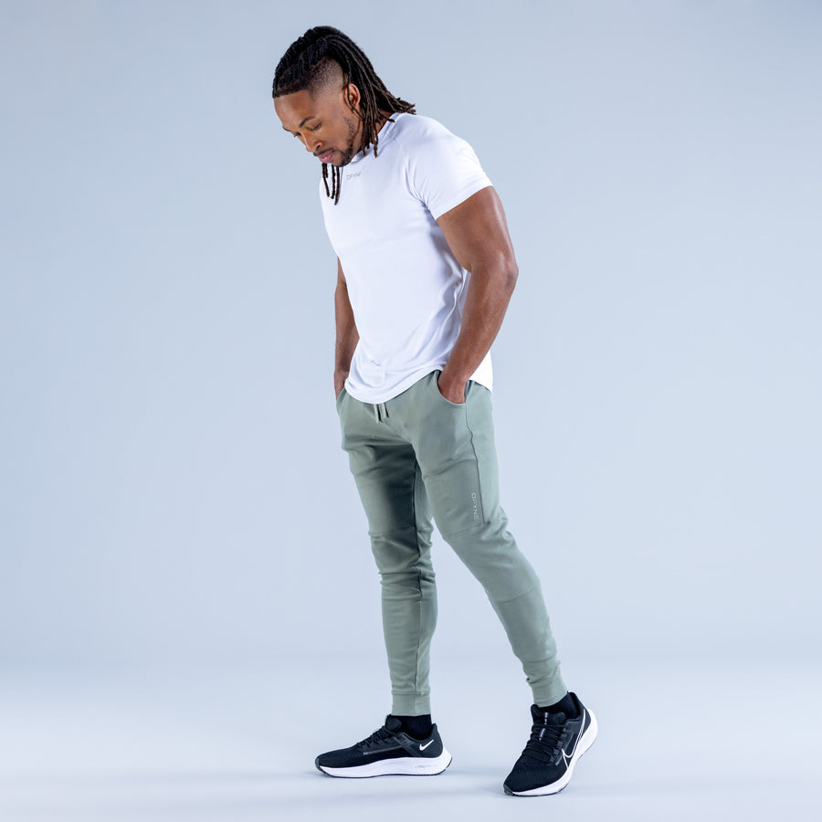 Sage green tapered jogger pants with drawstring waist and elastic cuffs