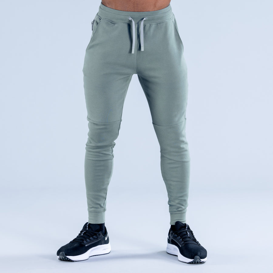 Sage green tapered jogger pants with drawstring waist and side pockets