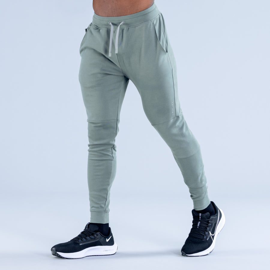 Sage green tapered jogger pants with drawstring waist and elastic ankle cuffs