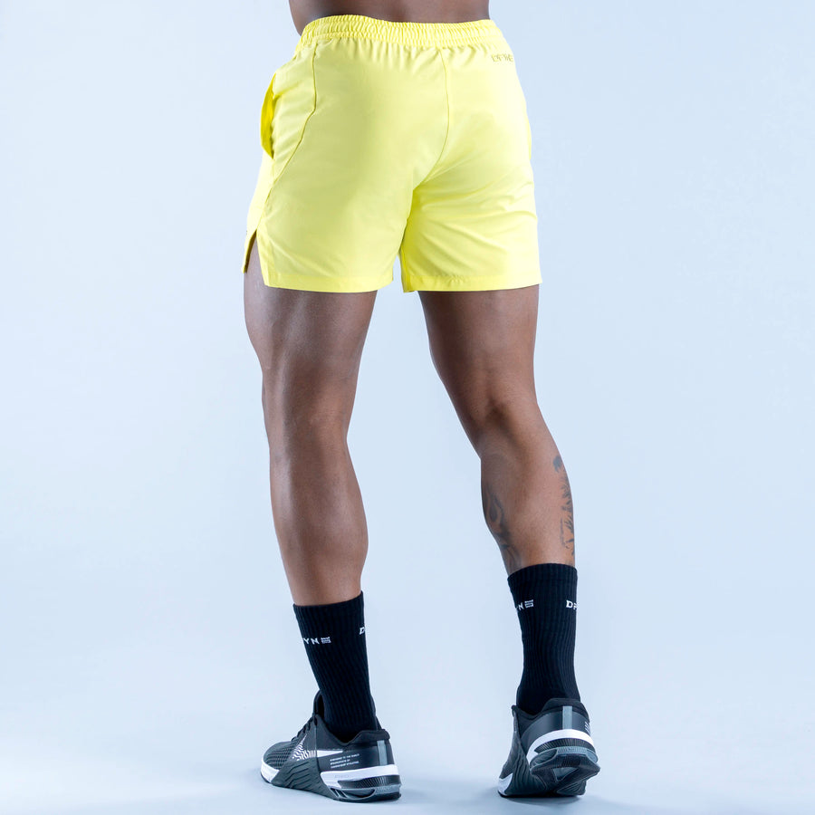 Lime yellow training shorts, back view with elastic waistband and back seam