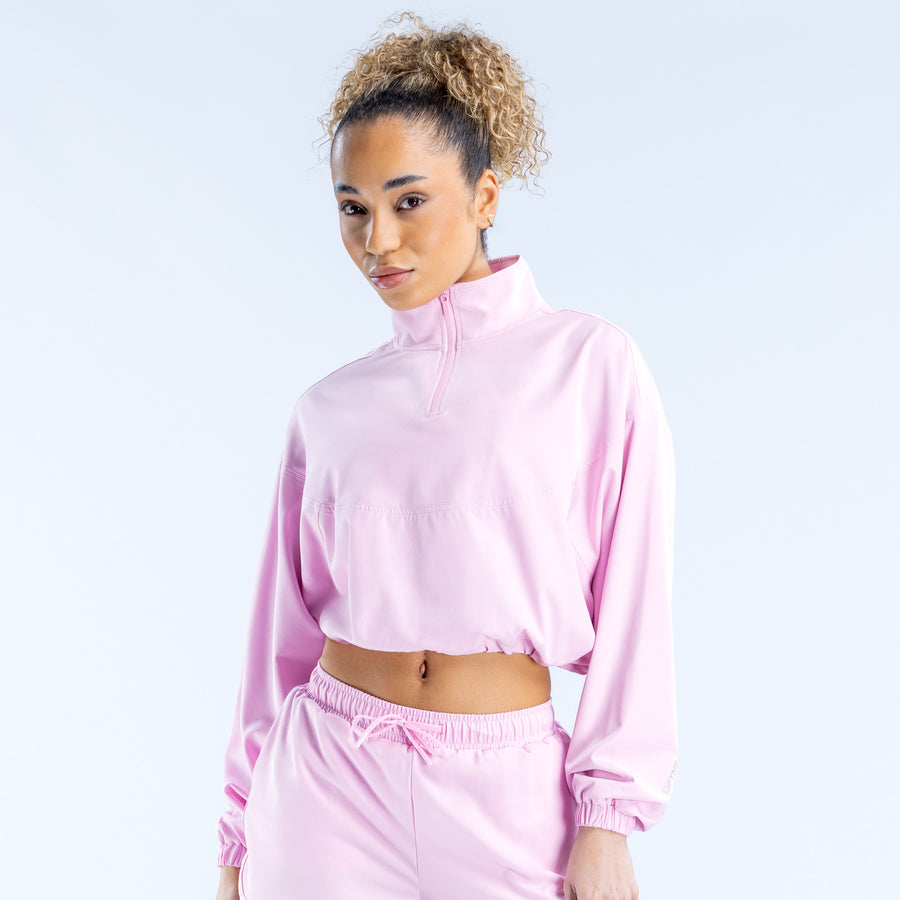 Light pink cropped zip jacket with zip-up collar and elastic hem