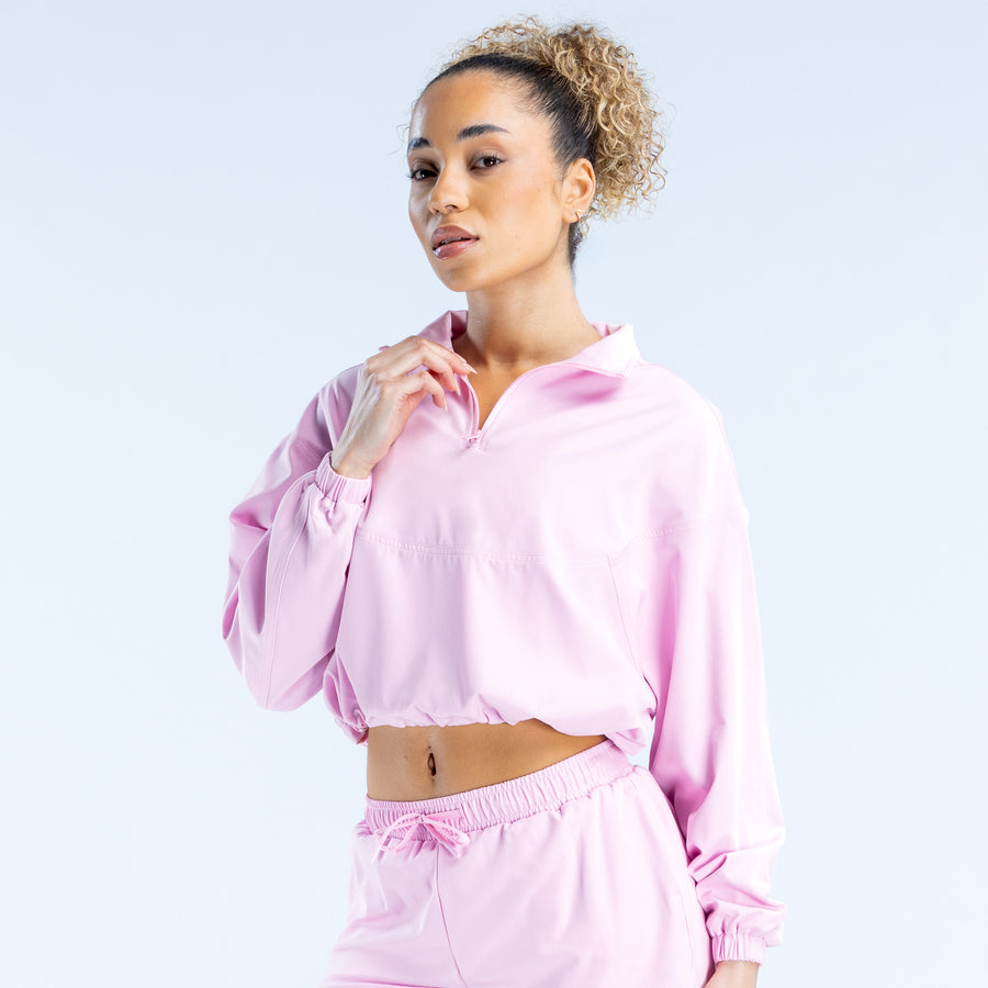 Light pink cropped zip jacket with half-zip style and elastic cuffs