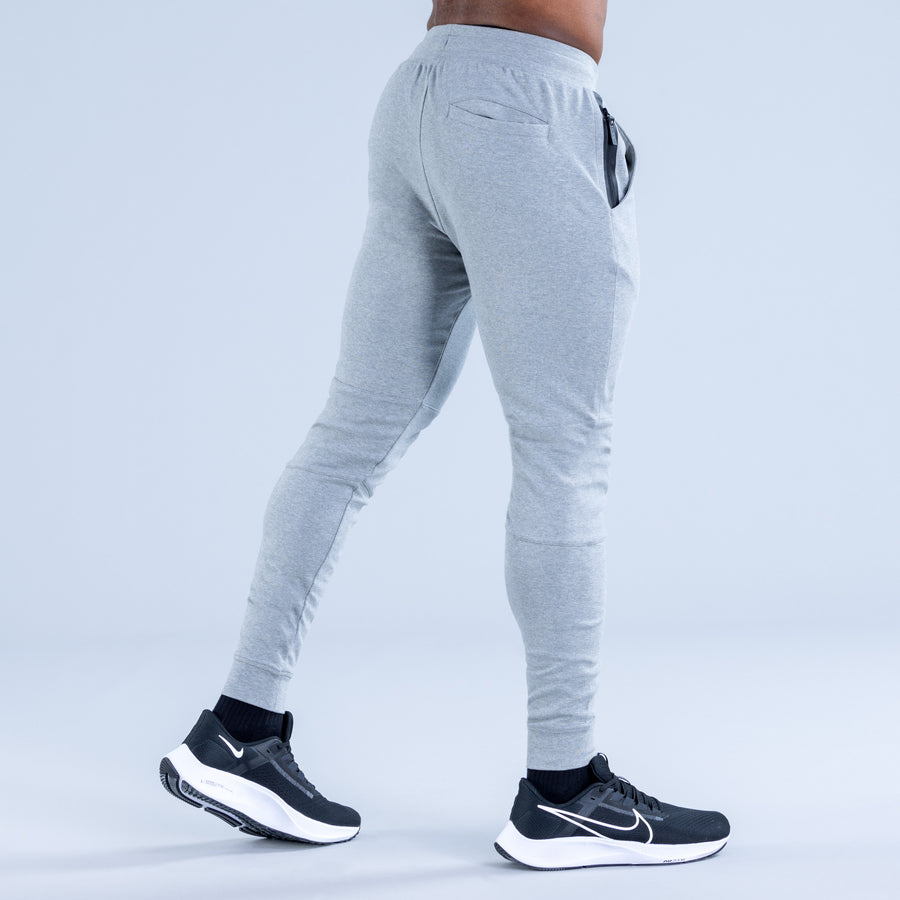 Light gray tapered jogger pants with drawstring and zip pocket