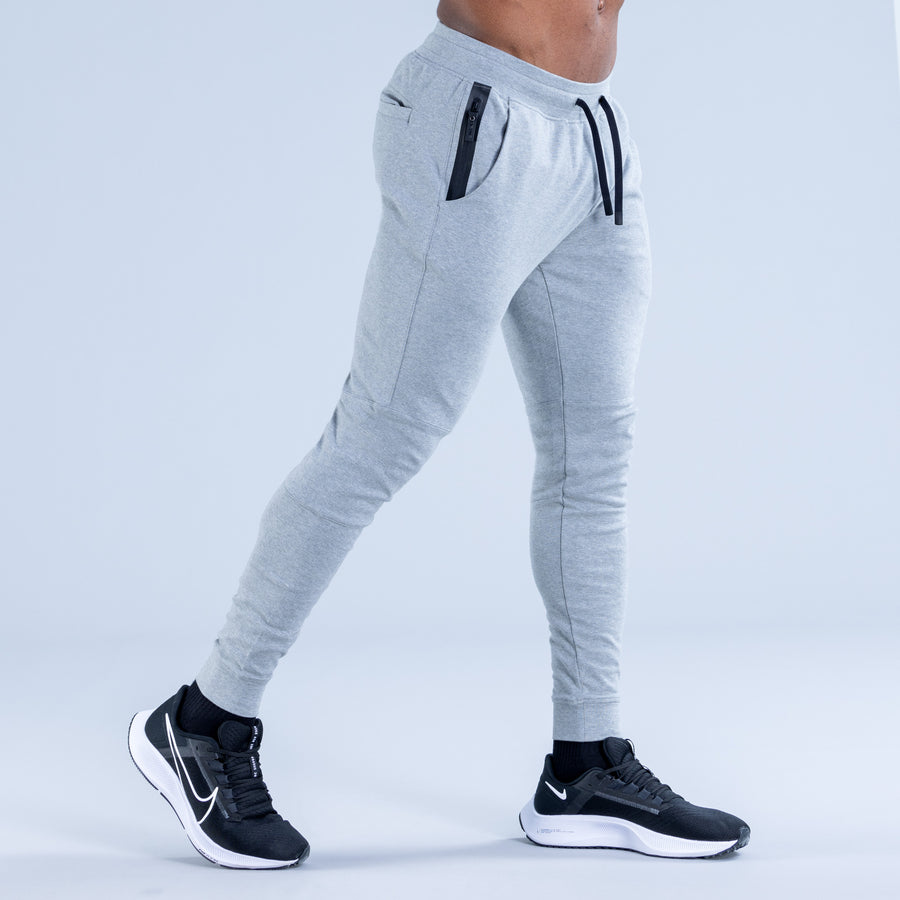 Light gray tapered jogger pants, side view with drawcord ankle cuff