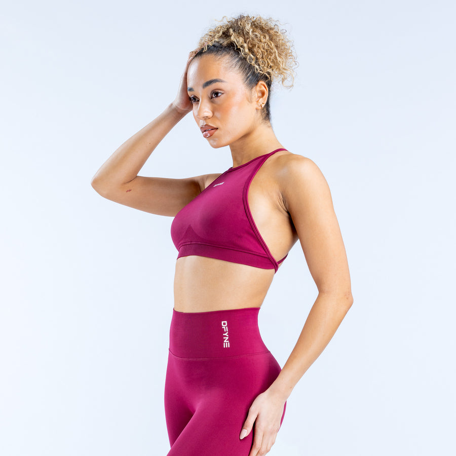 Burgundy high-neck sports bra with racerback straps and cropped fit