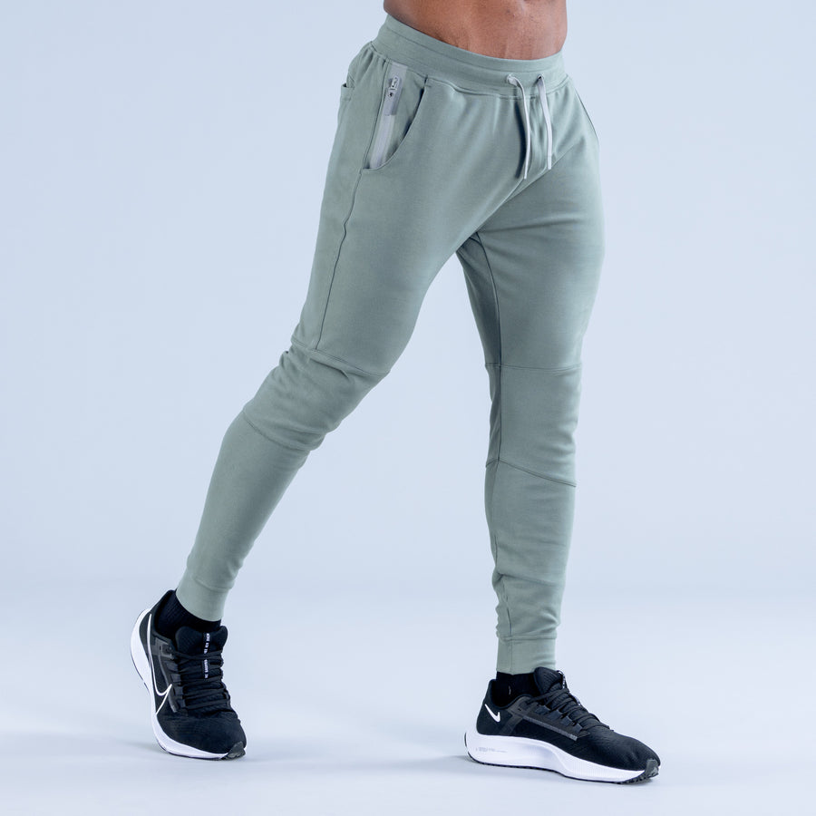 Sage green tapered jogger pants, side view, drawstring waist and tapered legs