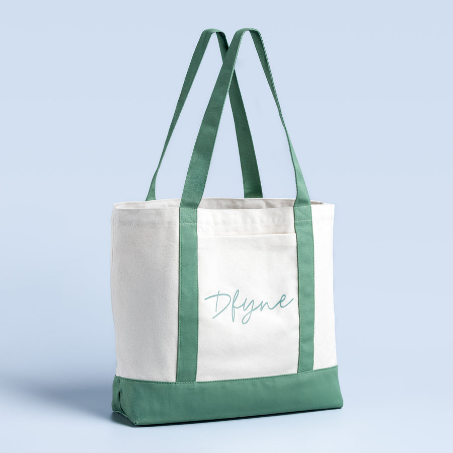 Two-tone tote bag: white body, green handles and base, cursive logo text