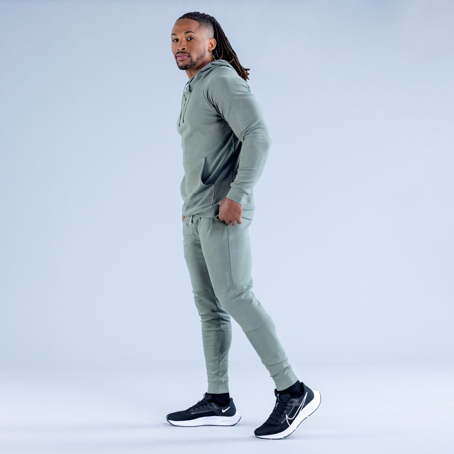 Sage green midweight hoodie with hood, front kangaroo pocket, and drawstring hem