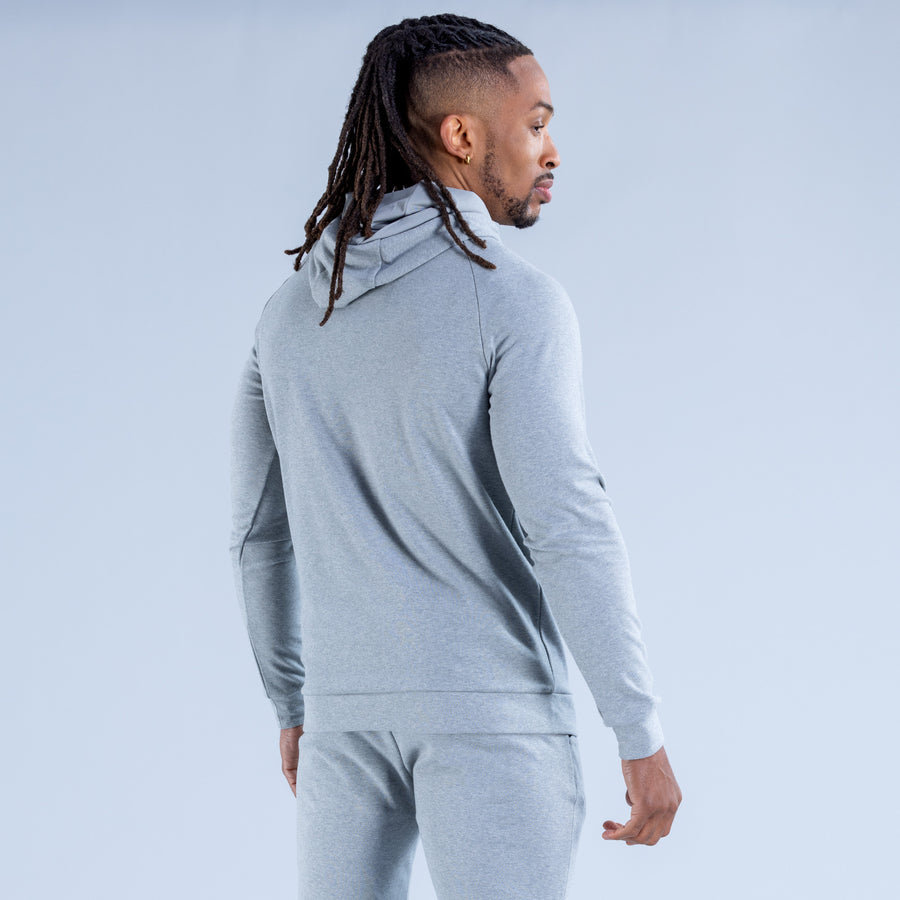 Light gray pullover hoodie with hood and drawstrings; kangaroo pocket and long sleeves.