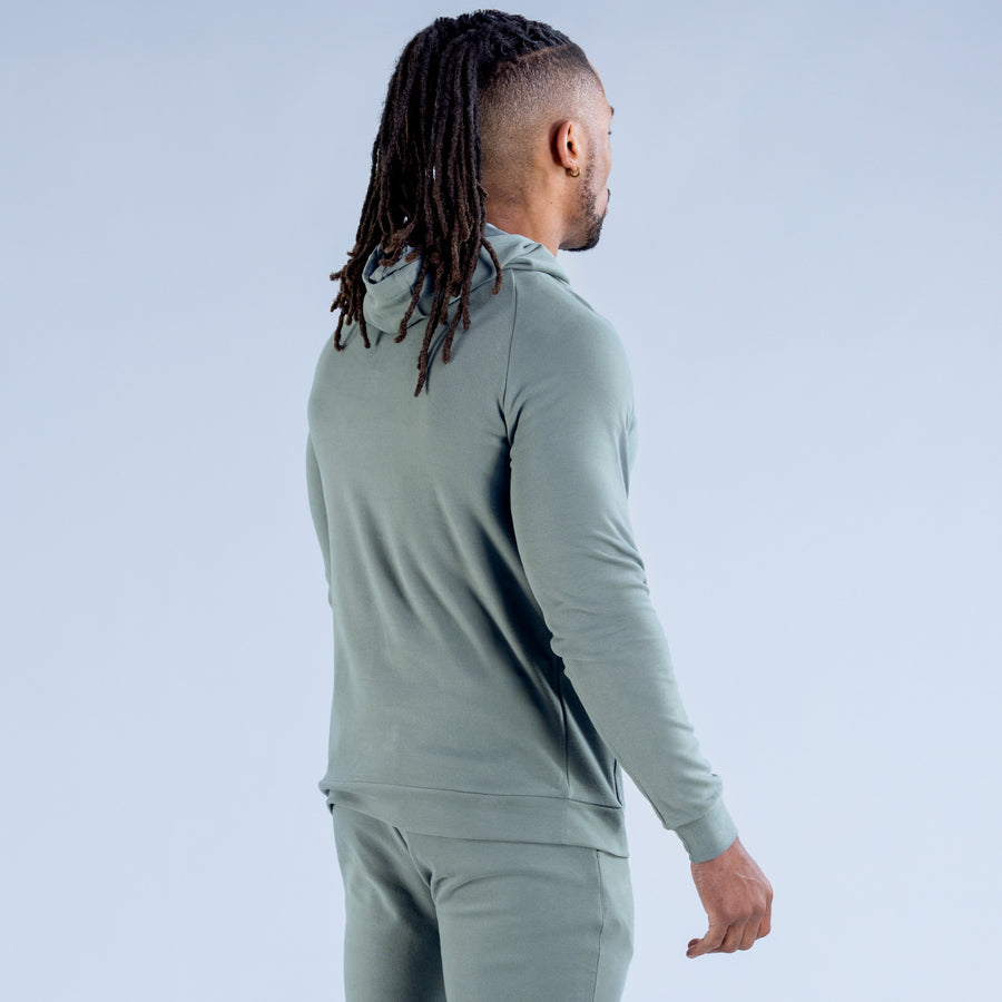 Sage green midweight hoodie, side profile showing long sleeves and kangaroo pocket