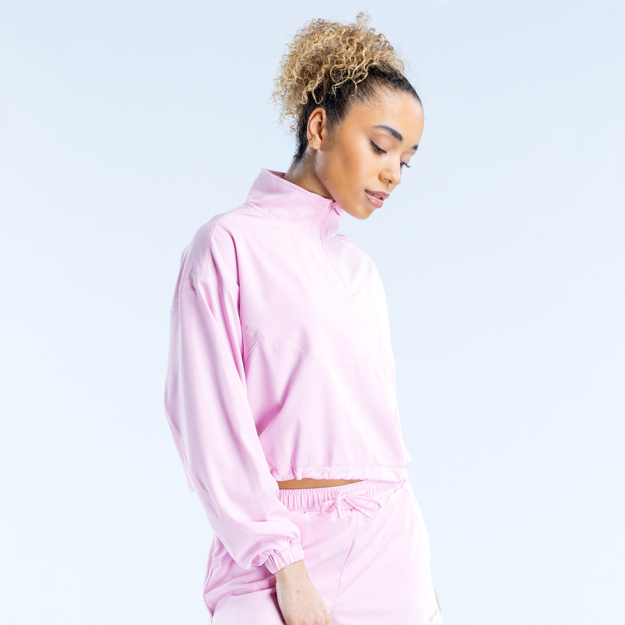 Light pink crop zip jacket with stand collar, zipped front, and cuffed sleeves