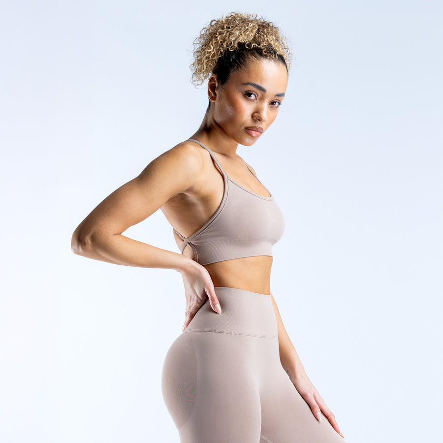 Light taupe sports bra with thin straps and scoop neckline