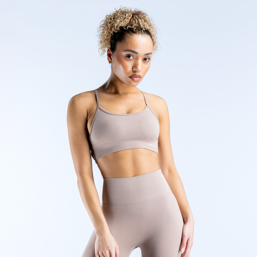 Light taupe sports bra with thin straps and wide elastic underband