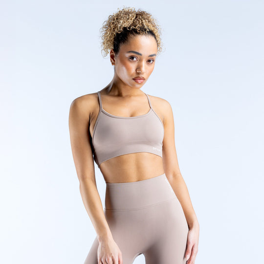 Taupe backless sports bra with adjustable straps and supportive scoop neckline