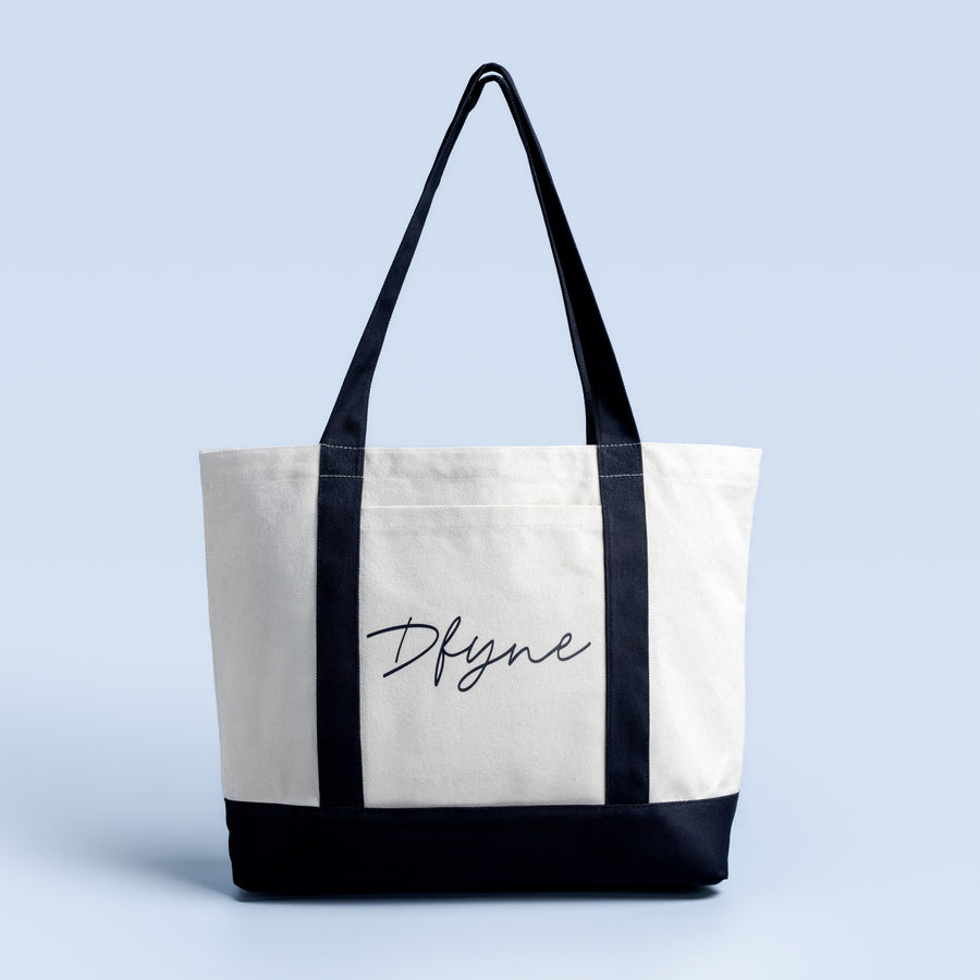 Canvas tote bag with dark top handles and Dfyne logo on front, black base