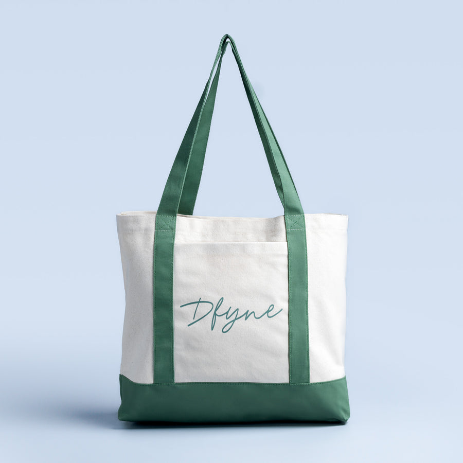 Tote bag with white panel and green trim, short handles, cursive logo text