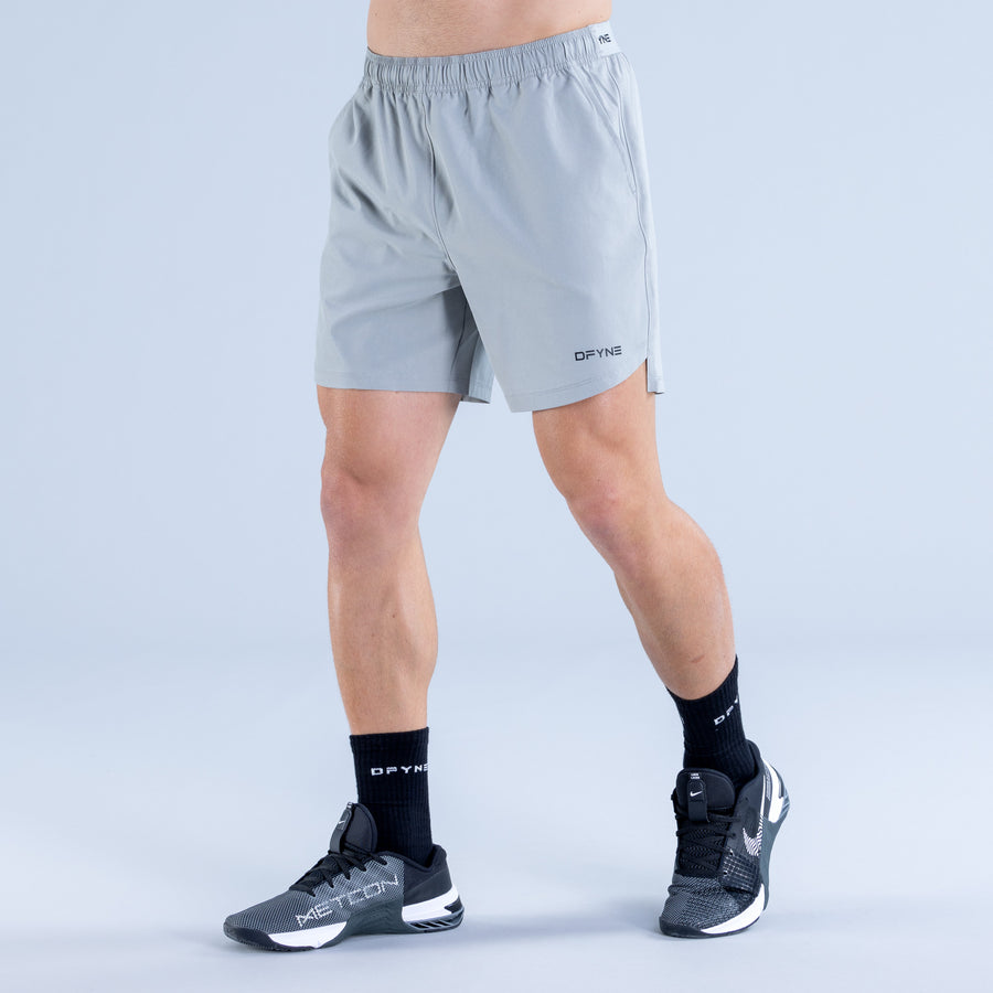 Light blue training shorts with elastic waistband and side pocket with DPYNE logo